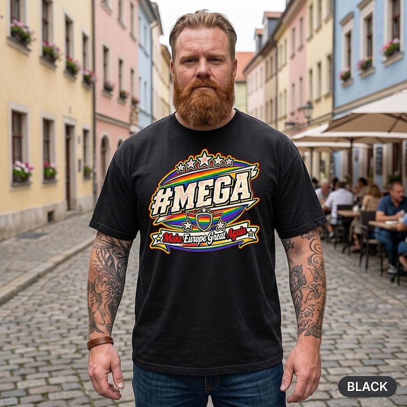 Bearded man in a European old town wearing the "#MEGA Make Europe Great Again" Rainbow Pride T-shirt by SarcasmArt in Black.