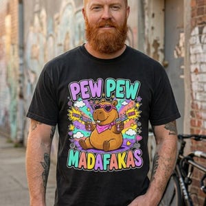 Bearded man on an urban street wearing the "Pew Pew Madafakas" capybara meme T-shirt by SarcasmArt in Black.