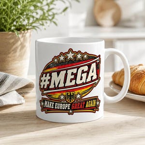 The "#MEGA Make Europe Great Again" Germany coffee mug by SarcasmArt on a bright desk with notebooks – a funny political gift for friends and family with Germany roots.