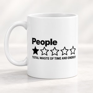May include: A white ceramic mug featuring black text that reads People followed by a single solid black star and four empty star outlines, with the text TOTAL WASTE OF TIME AND ENERGY printed in black capital letters underneath the stars.