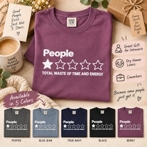 The "People – 1 Star, Total Waste of Time and Energy" sarcastic review T-shirt by SarcasmArt folded in Berry on a cozy flat lay with coffee and notes – available in 5 colors, a great gift for introverts and coworkers.