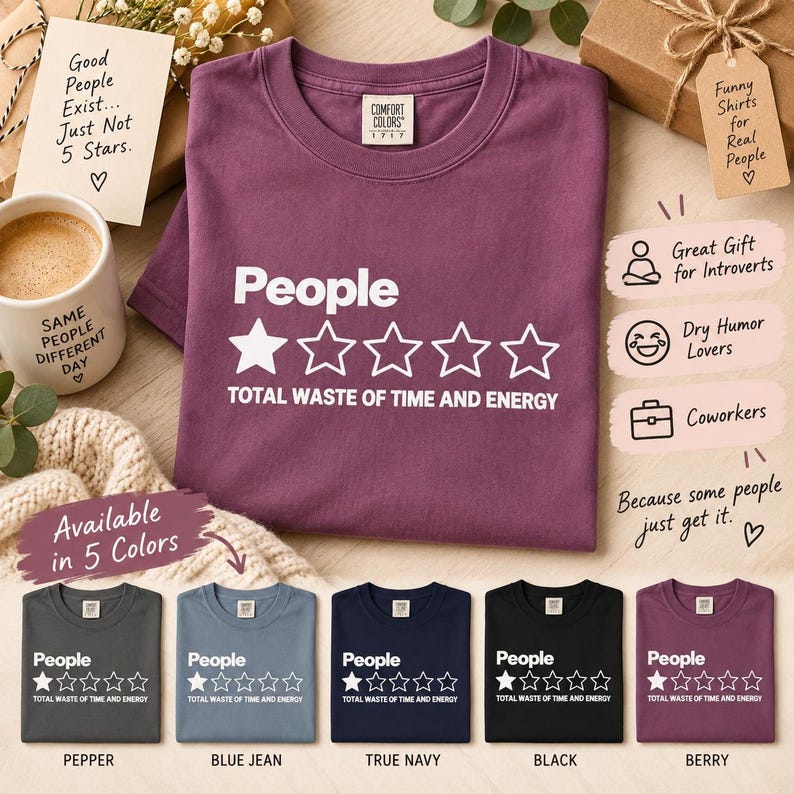The "People – 1 Star, Total Waste of Time and Energy" sarcastic review T-shirt by SarcasmArt folded in Berry on a cozy flat lay with coffee and notes – available in 5 colors, a great gift for introverts and coworkers.