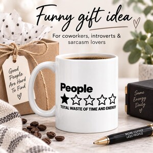 Funny gift idea: the "People – 1 Star, Total Waste of Time and Energy" sarcastic coffee mug by SarcasmArt with a gift box and coffee beans – for coworkers, introverts and sarcasm lovers.