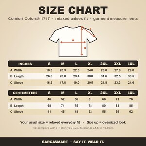 Size chart for the "Don't Worry Be Cappy" capybara beach T-shirt by SarcasmArt (Comfort Colors 1717): relaxed unisex fit, garment measurements in inches and centimeters for sizes S to 4XL.