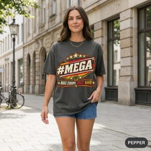 Woman walking down a Berlin-style city street wearing the "#MEGA Make Europe Great Again" Germany T-shirt by SarcasmArt in Pepper.