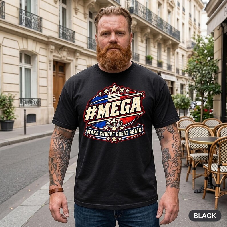 Bearded man in a European old town wearing the "#MEGA Make Europe Great Again" France T-shirt by SarcasmArt in Black.