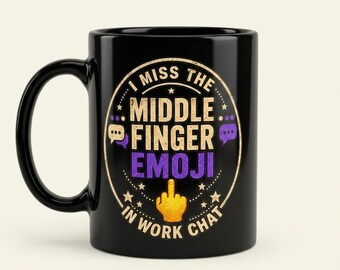 May include: A black ceramic mug featuring a circular graphic with the text I MISS THE MIDDLE FINGER EMOJI IN WORK CHAT. The design includes a yellow middle finger emoji, small stars, and purple speech bubble icons arranged in a circular border.
