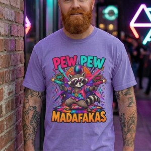 Bearded man in front of a neon-lit brick wall wearing the "Pew Pew Madafakas" raccoon meme T-shirt by SarcasmArt in Violet.