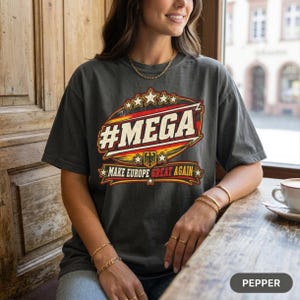 Woman with a coffee at a café window wearing the "#MEGA Make Europe Great Again" Germany T-shirt by SarcasmArt in Pepper.