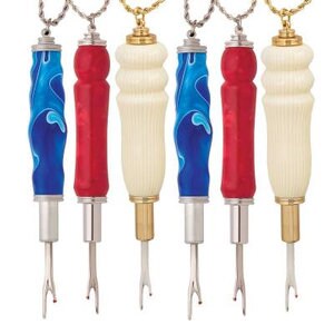 May include: Six decorative bottle stoppers with ornate handles. The handles feature blue and white swirls, solid red, and cream-coloured ribbed patterns. Each stopper has a metal base and a small fork-like tip.
