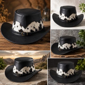 May include: A black leather cowboy hat featuring a white and black cow print fur band around the crown. The hat includes a braided black leather hatband with a small metal buckle detail. The design has a flat top and a wide, curved brim.