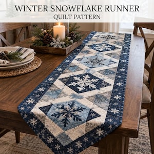 May include: A quilted table runner featuring a Winter Snowflake Runner Quilt Pattern with shades of navy blue, light blue, and white. The fabric displays repeating snowflake motifs in geometric diamond shapes with a dark blue border.