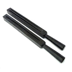 May include: Two black wooden dowels with grooves running along their length. The dowels are approximately 12 inches long and have rounded ends.