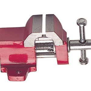 May include: A red metal bench vise with a silver handle and a spring mechanism. The vise is open and ready to clamp.