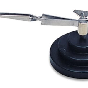 May include: A black ring holder with a rotating arm and tweezers for holding a ring. The holder has a black base with three tiers.