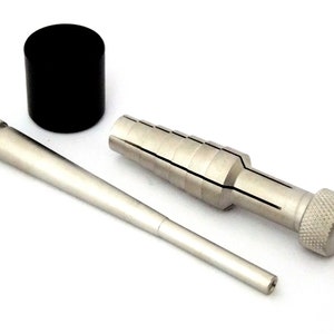 May include: A set of three silver metal tools for jewelry making. The tools include a mandrel, a ring sizing tool, and a black plastic ring sizing block.