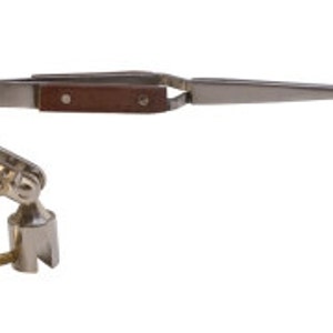 May include: A silver-toned, adjustable, articulated, swiveling, clamp-on tweezer holder with a pair of stainless steel tweezers with a brown wooden handle.