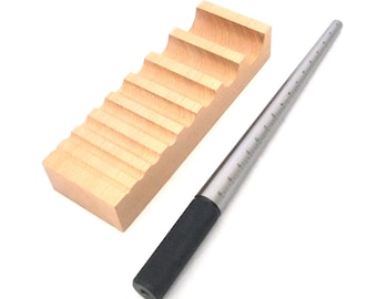 May include: A wooden ring sizing mandrel with 10 ring sizes and a metal ring sizer with a black handle. The ring sizer is marked with sizes 5 through 16.