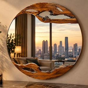 May include: A circular wall mirror featuring a thick, natural-edged wooden frame with organic, irregular cutouts at the top and bottom. The reflective glass surface displays a clear view of a city skyline at sunset, including tall buildings.