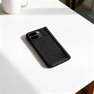 May include: A black smartphone case with a textured, pebbled surface finish. The case features a rectangular camera cutout at the top left corner, housing two circular camera lenses and a small flash. The design is sleek, slim, and rectangular.
