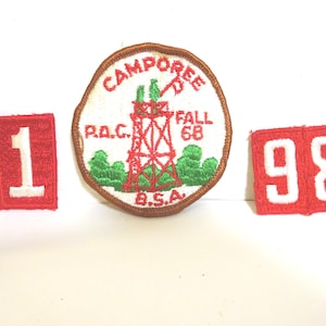 May include: Three vintage patches. A round patch with "Camporee Fall 68" text and a red tower design. Two rectangular patches with the numbers "1" and "98" in white on a red background. BSA.