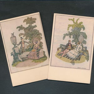 May include: Two vintage postcards featuring colorful illustrations of people in a garden setting. One shows a man and woman near a stone bench, the other depicts a couple with a guitar. The cards have a cream-colored border and are set against a dark background.