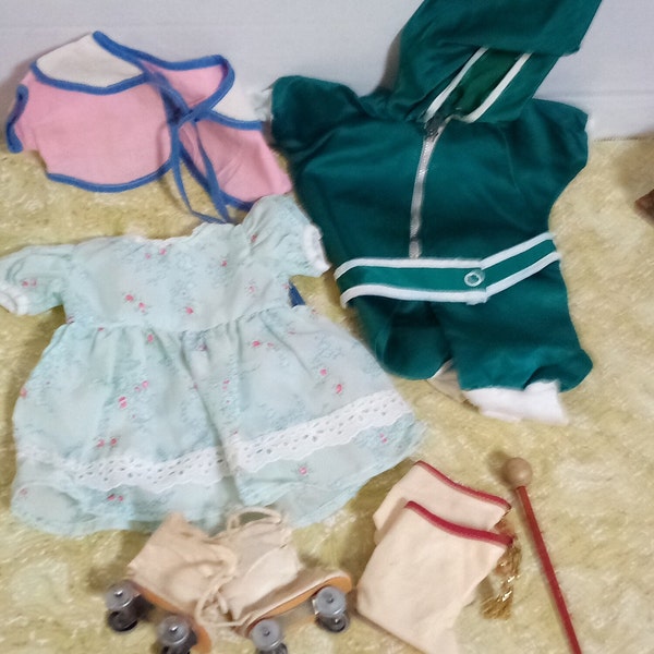 doll clothes: dress, jumpsuit, cape, roller skates, majorette shoes and baton