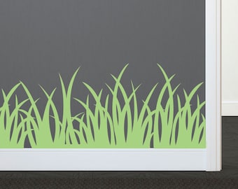 May include: A gray wall with a white trim and a white door. A green grass border decal is at the bottom of the wall.