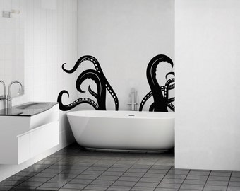 May include: A white bathtub with black octopus tentacles on the wall behind it. The bathroom has a white vanity with a black countertop and a mirror above it.