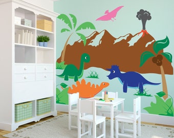 May include: A child's playroom featuring a white table and chairs set against a wall mural. The mural depicts a prehistoric scene with colorful dinosaurs, a volcano, and palm trees. A white cabinet and rug complete the room's decor.