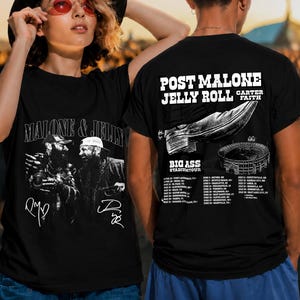 May include: A black t-shirt featuring a graphic of Post Malone and Jelly Roll with the text Malone & Jelly on the front. The back displays a cowboy boot, a stadium, the text Post Malone Jelly Roll Carter Faith Big Ass Stadium Tour, and dates.
