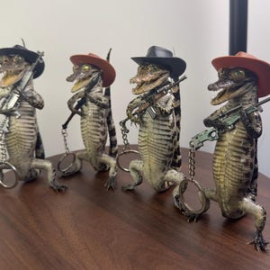 Realistic standing Alligator specimen – Western Cowboy Holding Various Firearm Props – Ethically Sourced Quirky Decor, Collectible Gift