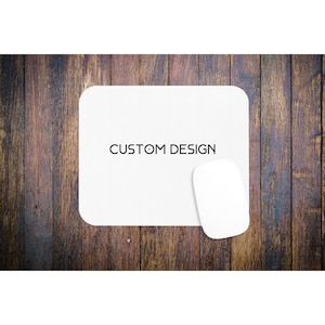 May include: White mouse pad with the text "CUSTOM DESIGN" on a wooden background.
