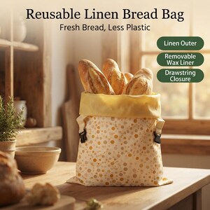 May include: A reusable linen bread bag with a cream and yellow polka dot pattern, containing several loaves of bread. The bag features a yellow interior, a drawstring closure, and text reading Reusable Linen Bread Bag, Fresh Bread, Less Plastic.