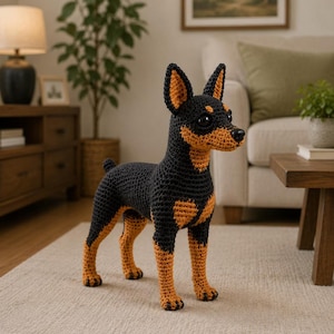 May include: A handcrafted crochet dog figurine featuring a black body with tan markings on the chest, legs, and ears. The toy has large dark eyes, a black nose, and pointed ears, standing in a realistic pose with a short tail and textured yarn.