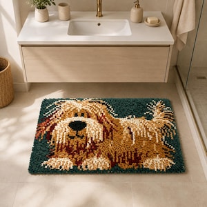 May include: A rectangular bath mat featuring a shaggy, textured pile design of a long-haired dog in shades of tan, cream, and dark brown. The dog is set against a deep teal background, creating a high-contrast, plush surface for bathroom floors.