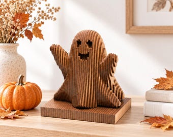 May include: A layered wooden ghost figurine with a dark brown finish, featuring a cutout face with square eyes and a mouth. The ghost is mounted on a rectangular wooden base and is constructed from multiple vertical slices of wood.