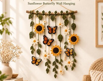 May include: A crochet pattern for a sunflower and butterfly wall hanging. The piece features yellow sunflowers, white daisies, and orange monarch butterflies suspended from a wooden branch by green crocheted vines and leaves.