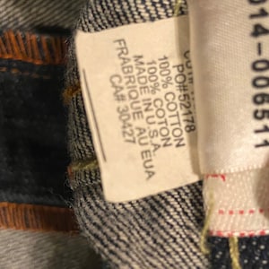 May include: A white tag with black text that reads "PO#52178 100% COTTON 100% COTON MADE IN U.S.A. FRABRIQUE AU EUA CA# 30427" and a white tag with black text that reads "514-006511".