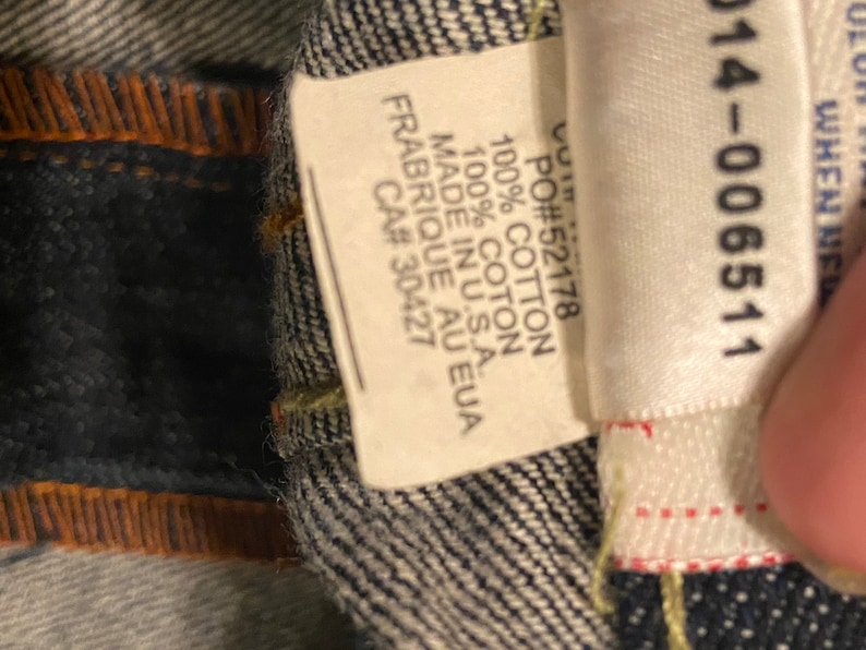 May include: A white tag with black text that reads "PO#52178 100% COTTON 100% COTON MADE IN U.S.A. FRABRIQUE AU EUA CA# 30427" and a white tag with black text that reads "514-006511".