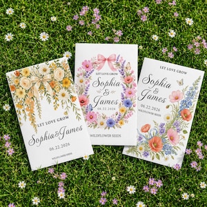 May include: Three white rectangular seed packets featuring floral illustrations and the text Let Love Grow, Sophia & James, and 06.22.2026. The left packet has yellow flowers and a bow, the center has a floral wreath with a pink bow, and the right has a floral spray.