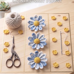 May include: Crochet Aster Flower Instant PDF Download. Three blue and white crocheted flowers with yellow centers, a ball of white yarn, metal scissors, a sewing needle, and several small yellow crocheted flower accents arranged on a board.