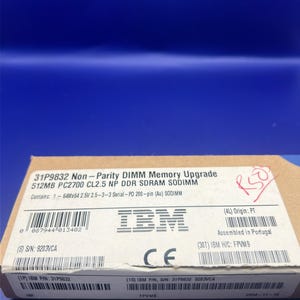 May include: A rectangular cardboard box containing a 512MB PC2700 CL2.5 NP DDR SDRAM SODIMM memory upgrade. The label displays the IBM logo, the part number 31P9832, various barcodes, serial number 9203VCA, and the text Assembled in Portugal.