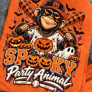 May include: An orange sweatshirt featuring a graphic of a monkey wearing a baseball cap and sunglasses, holding two plaid baseball bats. The design includes jack-o'-lanterns, a ghost, bats, and the text "SPOOKY Party Animal" with a baseball.