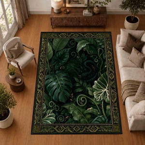 May include: A rectangular area rug featuring a dark green botanical pattern of large monstera and tropical leaves with swirling vines. The rug is framed by a decorative black and gold border with a repeating geometric diamond and line motif.