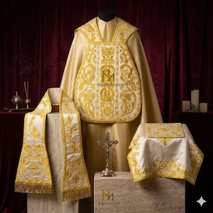 May include: A gold-colored liturgical chasuble featuring intricate white and gold embroidery, accompanied by a matching stole with gold fringe and a chalice veil. The central panel displays the text bigmesson in a dark font.