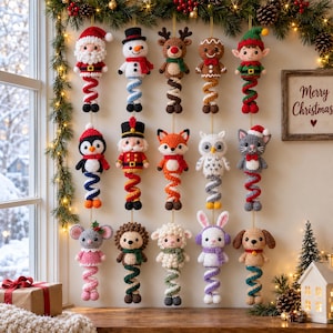 May include: A collection of fifteen hanging crochet ornaments featuring various characters including Santa, a snowman, reindeer, gingerbread person, elf, penguin, nutcracker, fox, owl, cat, mouse, hedgehog, sheep, rabbit, and dog, each with a spiral base.
