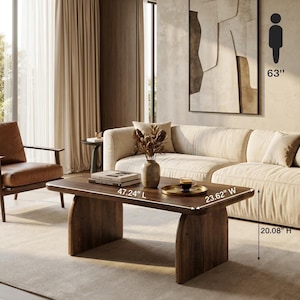May include: A dark brown wooden coffee table with a rectangular top and two curved slab legs. The table measures 47.24 inches long, 23.62 inches wide, and 20.08 inches high. It features a smooth surface holding a vase with dried botanicals and a tray.