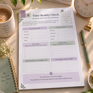 May include: A white paper planner page titled Time Reality Check with sections for My Available Time, My Energy Levels, Time Drains, Time Boosters, and What's Realistic for Me Right Now. The page features purple and green accents and text.