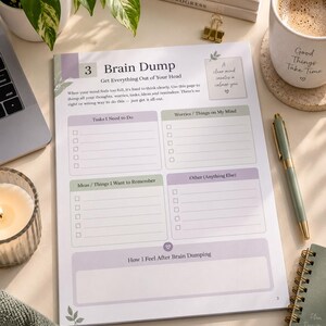 May include: A white paper planner page titled Brain Dump with sections for Tasks I Need to Do, Worries, Ideas, and Other. The page features soft purple and green accents, checkboxes, and lines for writing. It includes the text Get Everything Out of Your Head and a small box stating A clear mind creates a calmer you.